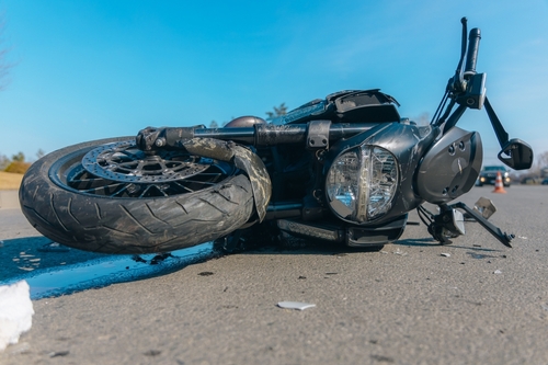 A damaged motorcycle lying on the road after a crash, illustrating cases affected by Washington motorcycle accident bias.